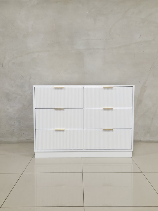 Naku Compactum with golden handles and ripple drawer detail, perfect for nursery storage.