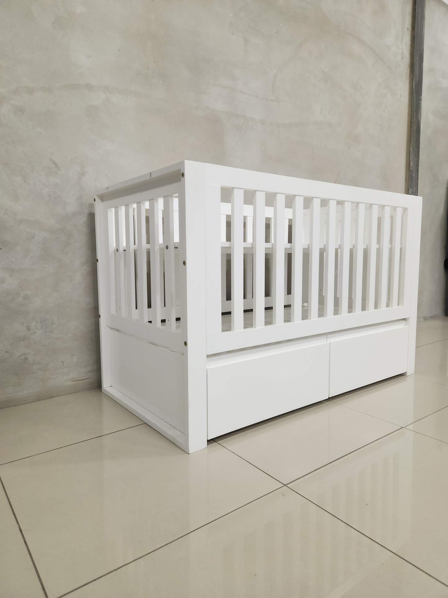 White cot with square frame design, toddler bed conversion, and built-in storage drawers.