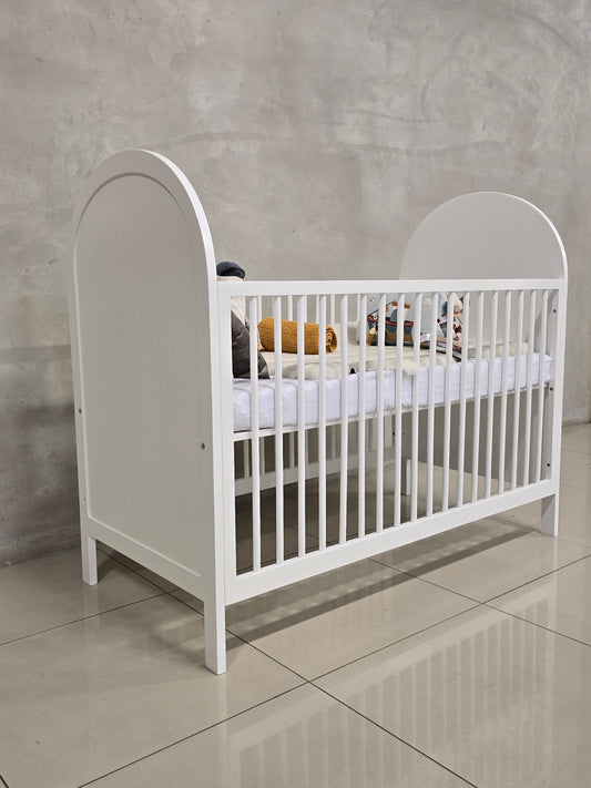 Bold Cot in white with a sleek and modern design for a nursery