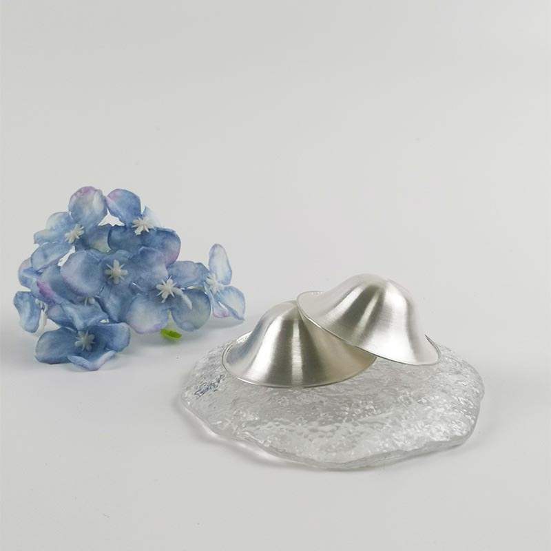 Pure silver nipple cups designed to promote healing during breastfeeding.