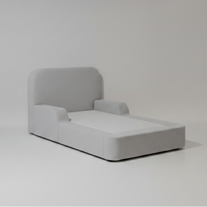 Gray upholstered kids bed on a plain background