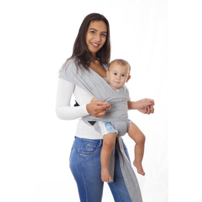 Parent wearing the SnuggleRoo Baby Carrier in the Newborn position, cradling a sleeping infant