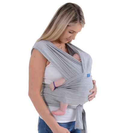 Parent wearing the SnuggleRoo Baby Carrier in the Newborn position, cradling a sleeping infant