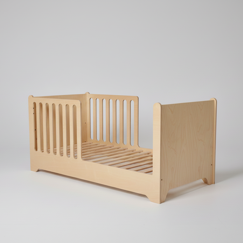 Wooden toddler bed on a plain background