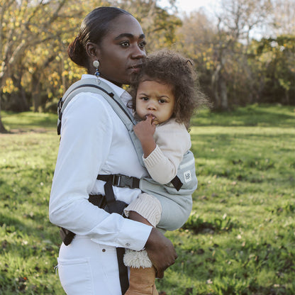 Mother wearing child on her back using the Ubuntu Baba Stage 2 Carrier