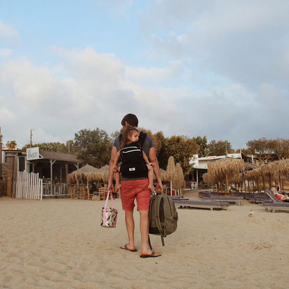 Mother wearing child on her back using the Ubuntu Baba Stage 2 Carrier.