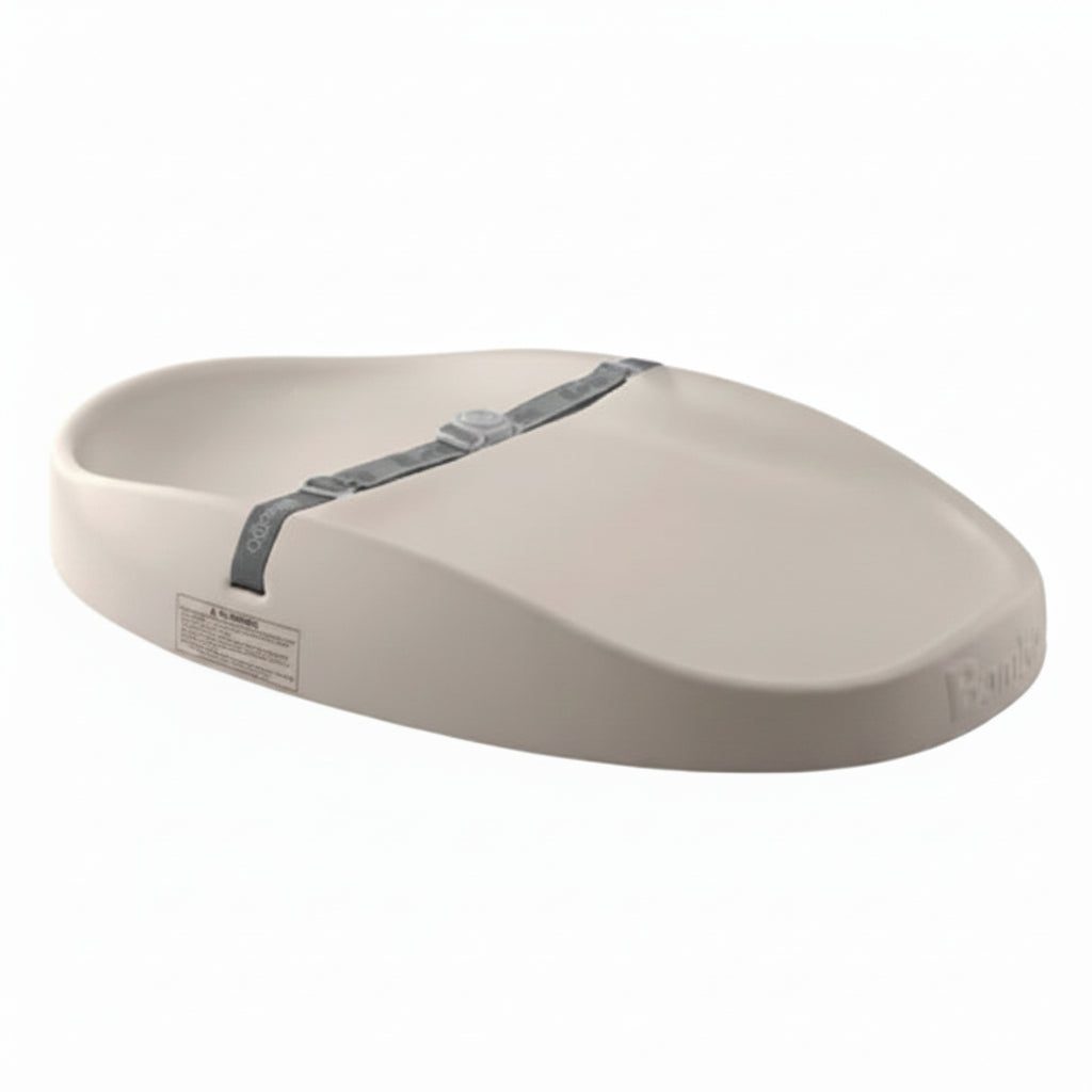 Beige changing mat with a grey strap on a white background