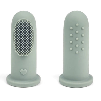 Soft silicone finger toothbrush gently cleaning baby’s gums
