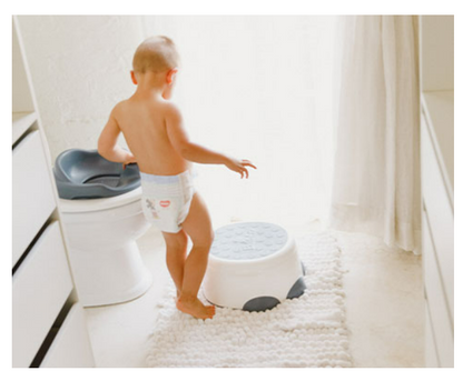 Toddler using Bumbo® Step 'n Potty as a toilet trainer.