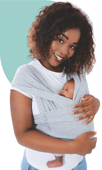 Parent wearing the SnuggleRoo Baby Carrier in the Newborn position, cradling a sleeping infant