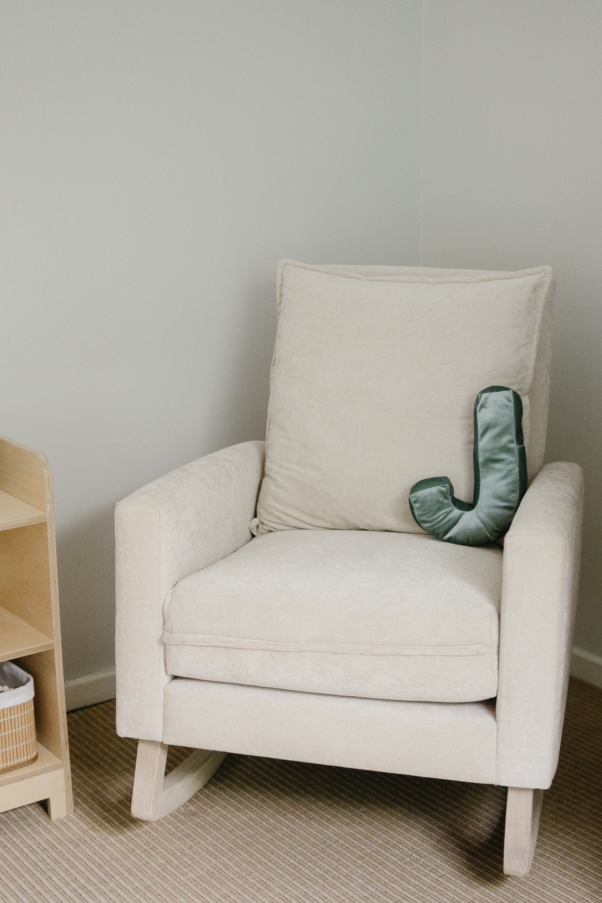 Ash wood Swag Rocking Chair with loose plush back cushion, ideal for relaxing spaces.