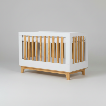 White crib with wooden slats on a gray background