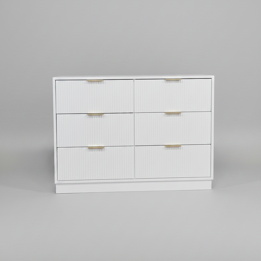 White dresser with gold handles on a gray background