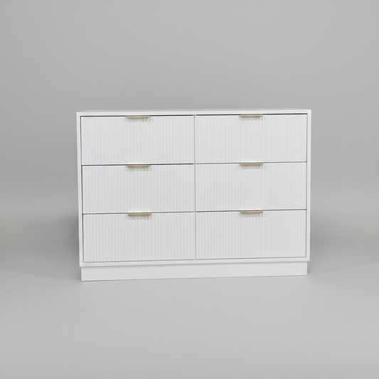 White dresser with gold handles on a gray background