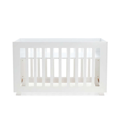 Pinkfoot Cot in white MDF styled in a modern nursery with plush bedding.
