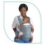Parent wearing the Snuggletime Airflow Hip Seat Carrier in a front-carry position with baby