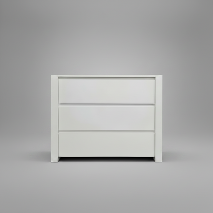 White nursery compactum with three drawers on a gray background