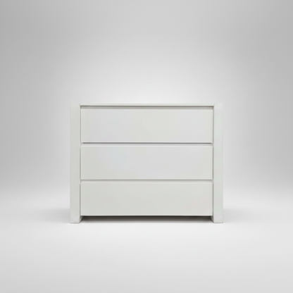White dresser with three drawers on a light gray background