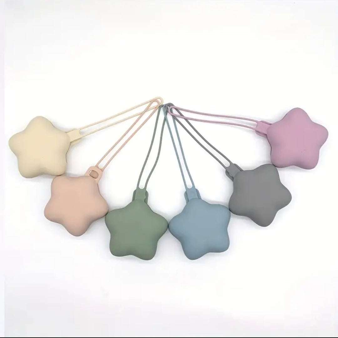 Set of colorful star-shaped dummy holders on a white background
