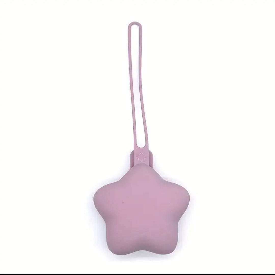 Pink star-shaped dummy holder with a strap on a white background