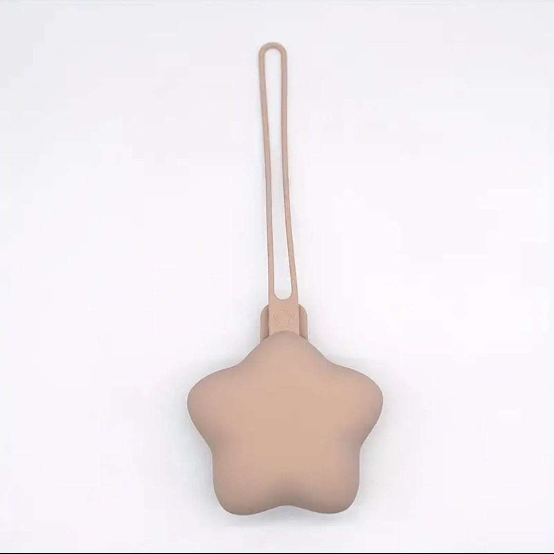 Star-shaped beige dummy holder with a string on a white background